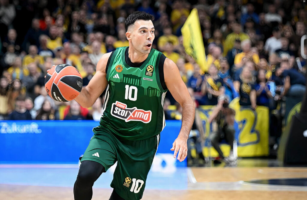 Kostas Sloukas driblinguoja kamuolį krepšinio aikštelėje